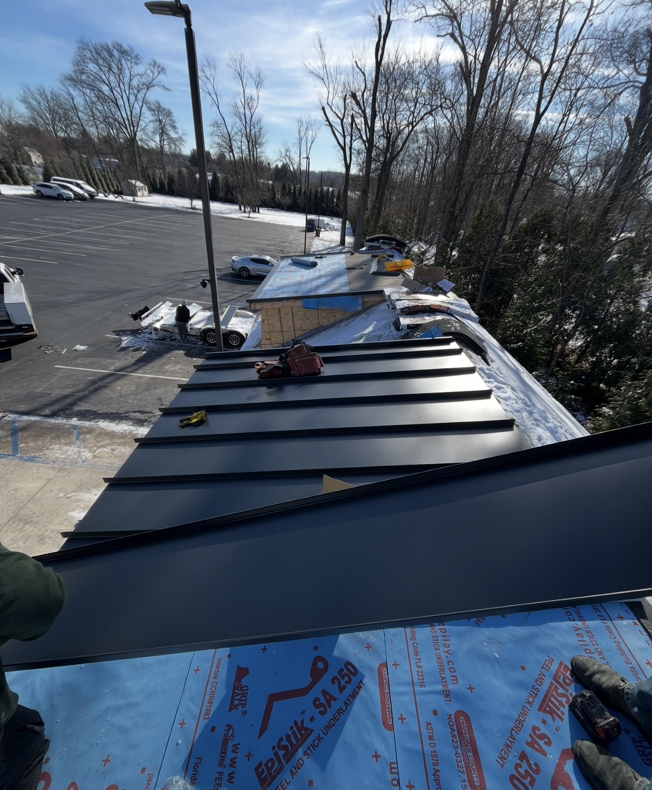 Metal panels and underlayment on a roof during installation